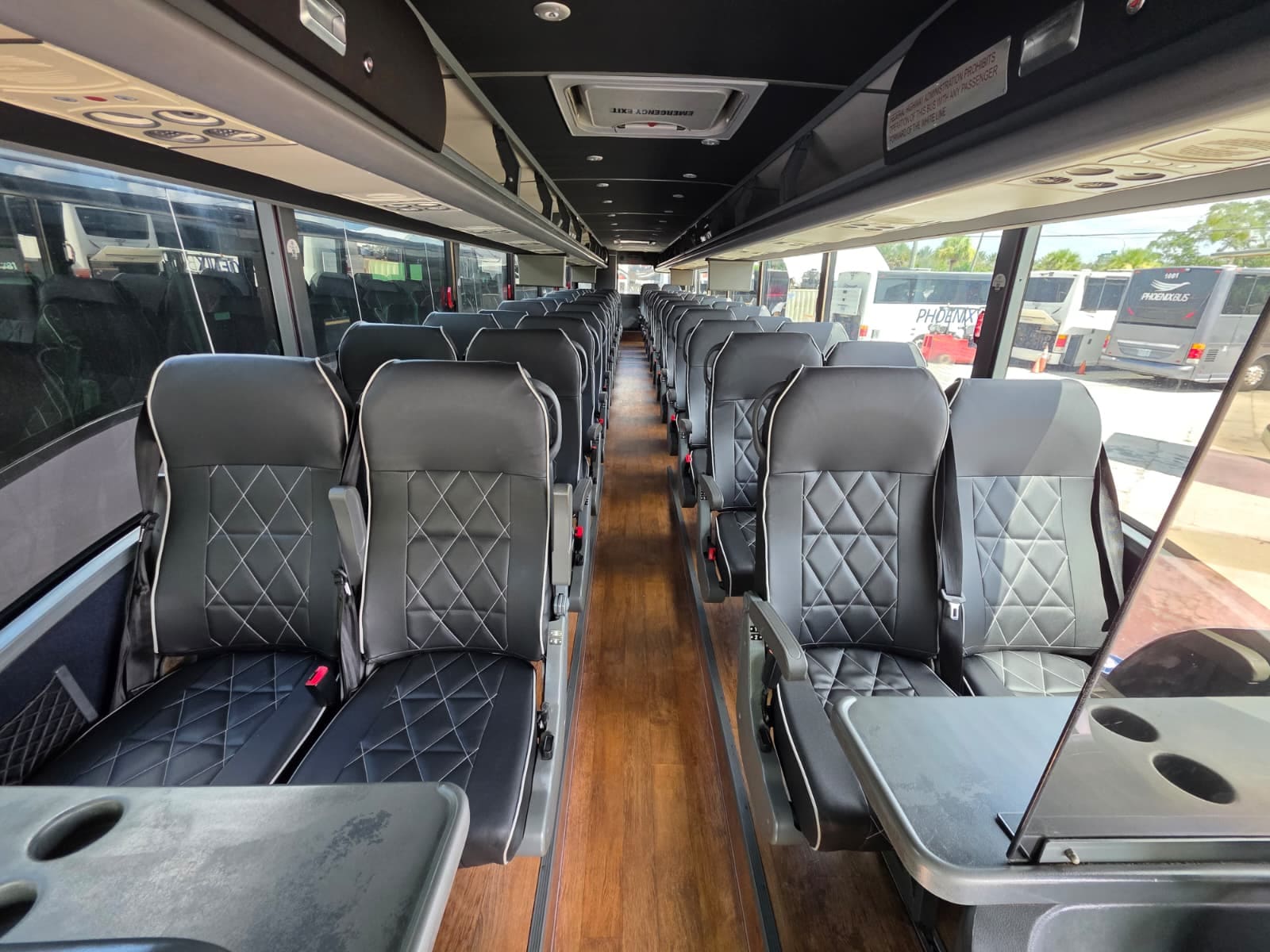 Cabin seating with fold-down tables and diamond-stitched leather